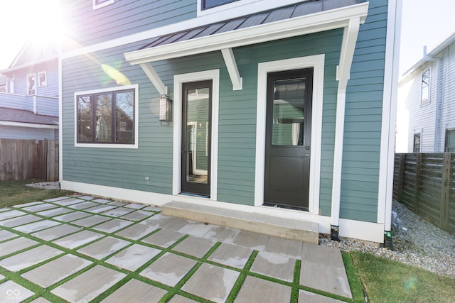 2133 N Talbott St, Indianapolis, IN 46202 - doorway to property featuring a metal roof, a standing seam roof, and a patio