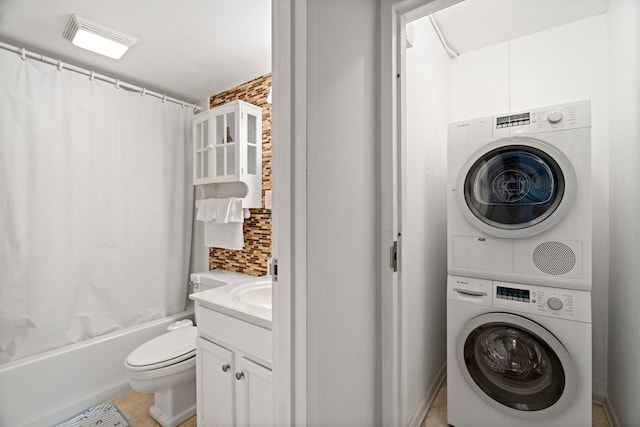 clothes washing area featuring sink, light tile floors, and stacked washer / dryer