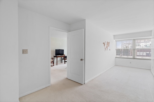 hall with light colored carpet