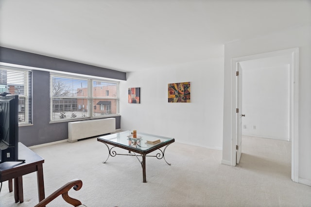 carpeted living room featuring a wealth of natural light and radiator heating unit