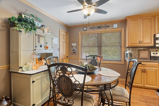 dining room featuring ceiling fan, light hardwood / wood-style flooring, and ornamental molding