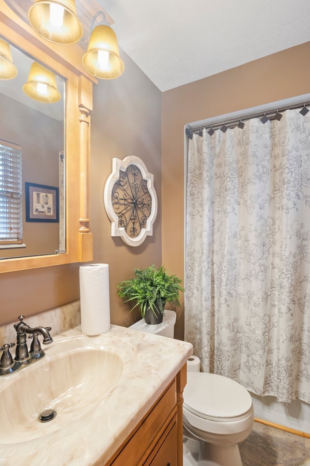 bathroom featuring toilet and vanity