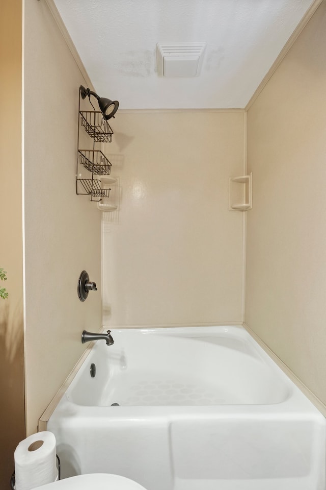 bathroom with toilet and washtub / shower combination