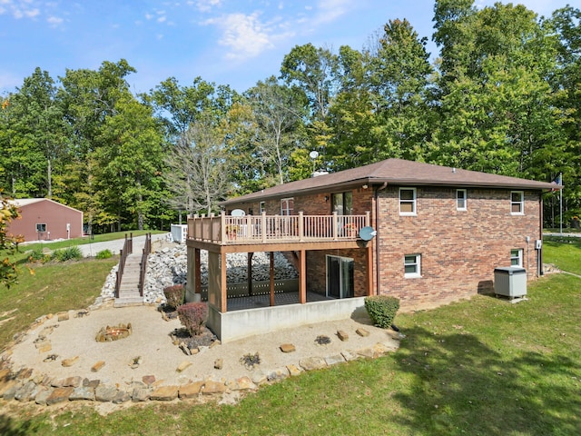 back of house with a wooden deck, a patio area, and a yard