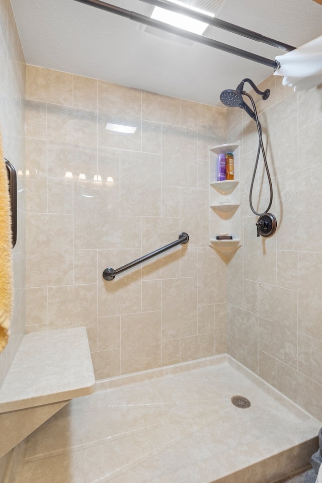 bathroom with tiled shower