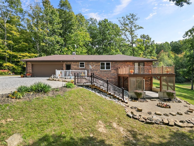 view of front facade featuring a wooden deck, a patio area, and a front lawn