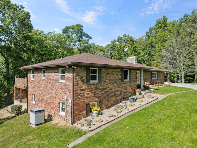 view of home's exterior with a yard and central air condition unit