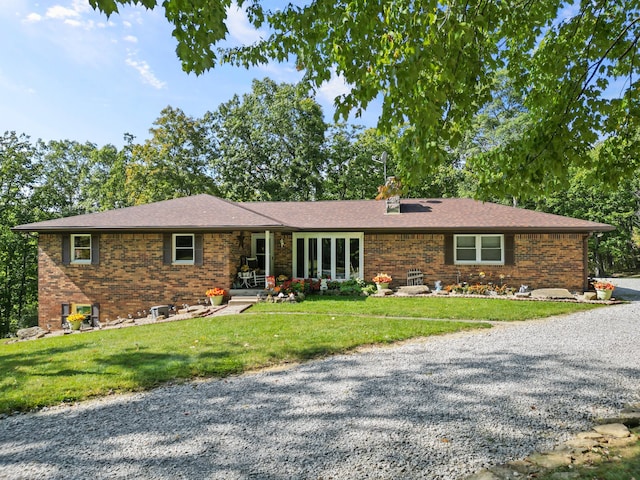 ranch-style home featuring a front yard