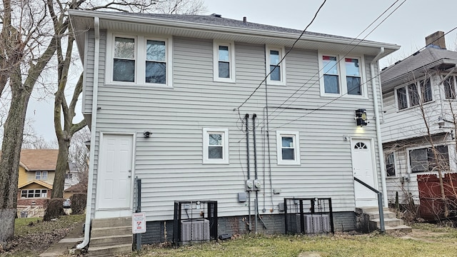 rear view of property featuring central AC unit