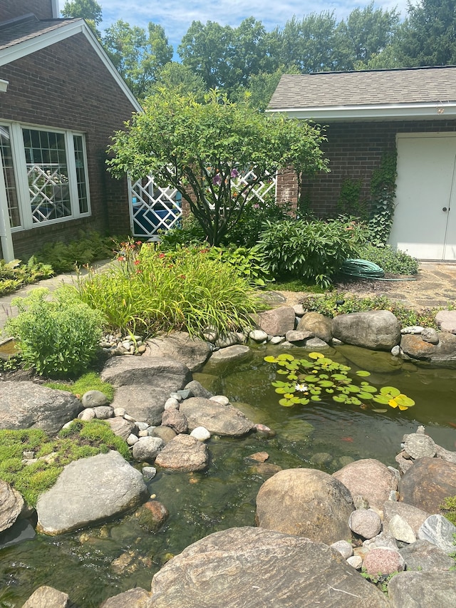 view of yard featuring a small pond