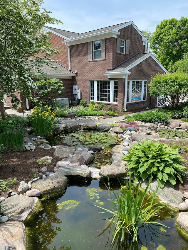 view of front facade featuring a small pond