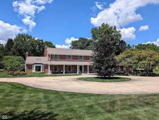 colonial home with a front lawn