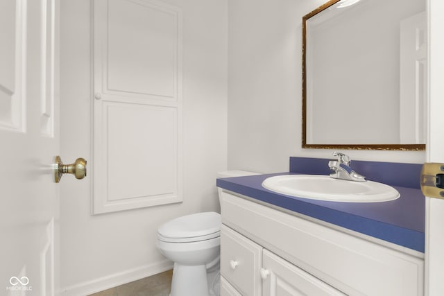 bathroom featuring tile patterned flooring, vanity, and toilet