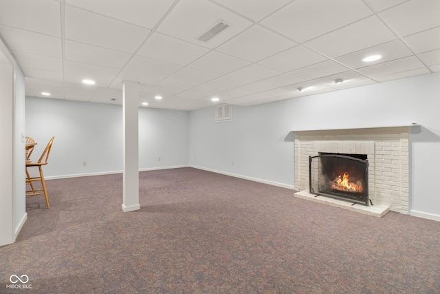 basement with dark carpet and a brick fireplace