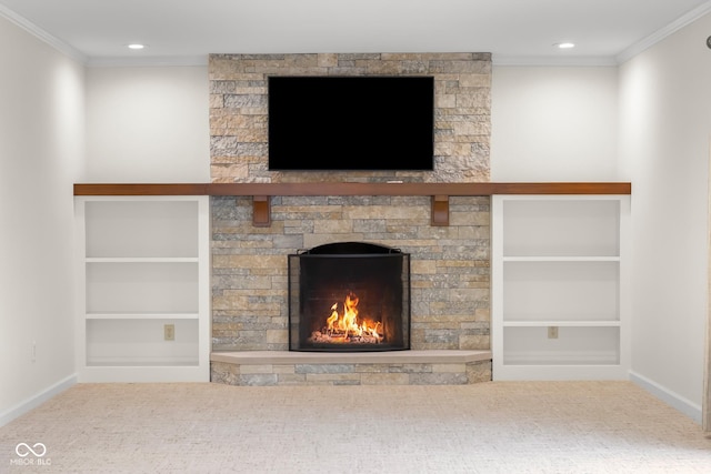 unfurnished living room featuring crown molding, a stone fireplace, carpet floors, and built in features