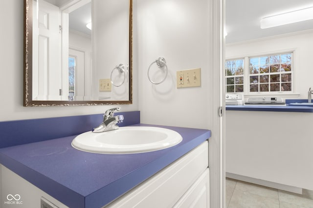 bathroom featuring tile patterned flooring, vanity, and crown molding