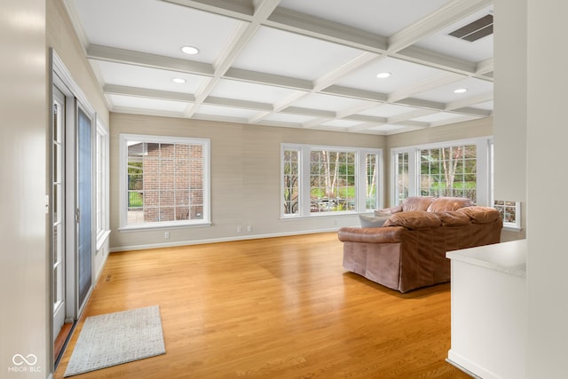 unfurnished living room with coffered ceiling, beam ceiling, and light hardwood / wood-style flooring