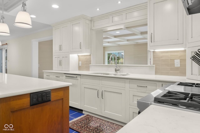 kitchen with coffered ceiling, sink, tasteful backsplash, pendant lighting, and white cabinets