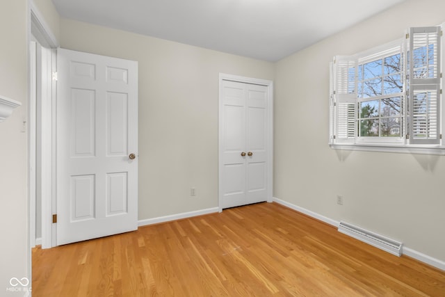 unfurnished bedroom with a closet and light wood-type flooring