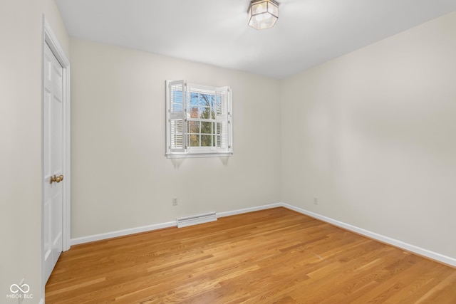 empty room with light hardwood / wood-style flooring