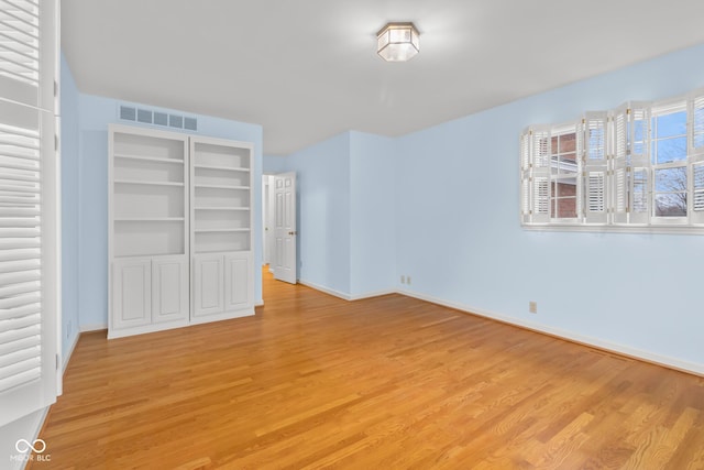 unfurnished bedroom with a closet and light wood-type flooring