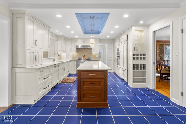 kitchen with sink, a kitchen island, and white cabinets