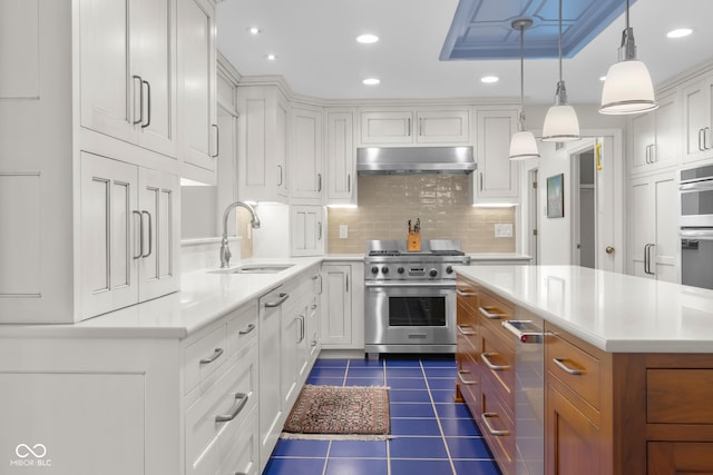 kitchen with white cabinetry, sink, decorative light fixtures, and stainless steel appliances