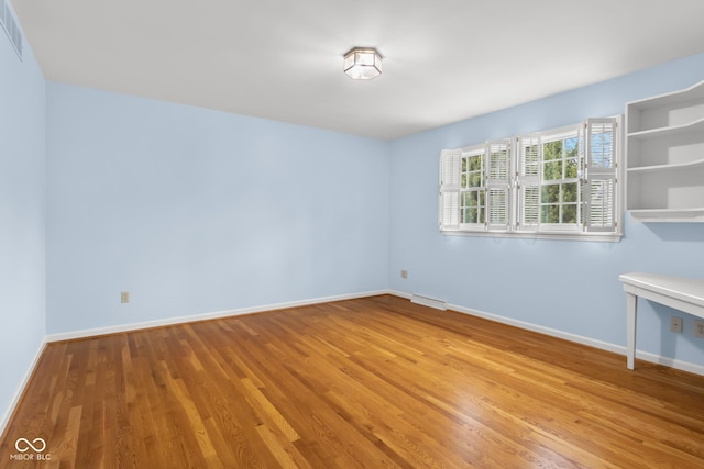 spare room with light hardwood / wood-style flooring