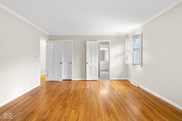 spare room with crown molding and light hardwood / wood-style flooring