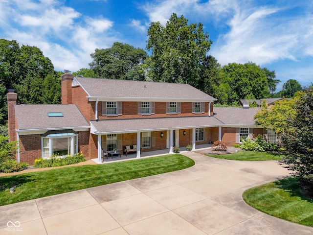 view of front of home featuring a front yard and a porch