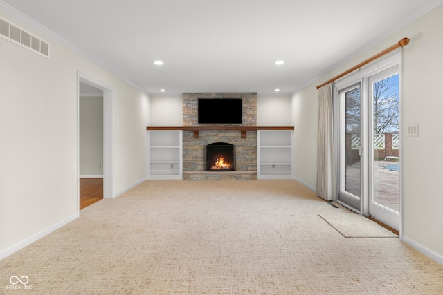 unfurnished living room featuring crown molding, carpet floors, and a fireplace