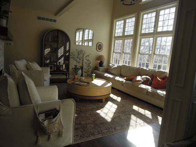 living room featuring wood-type flooring and beam ceiling