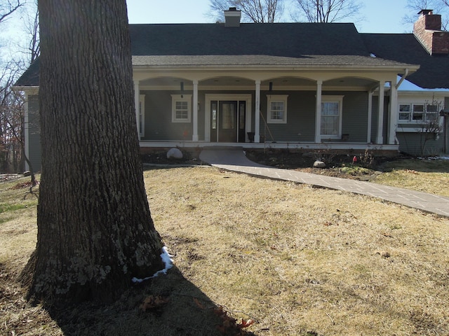 bungalow-style house with a porch and a front lawn