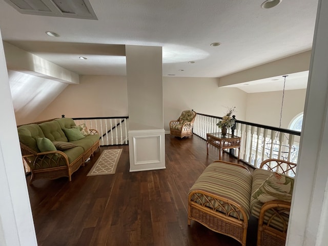 sitting room featuring vaulted ceiling with beams and dark hardwood / wood-style flooring