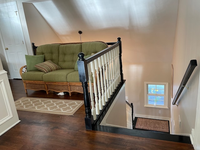 stairs with dark hardwood / wood-style floors and lofted ceiling