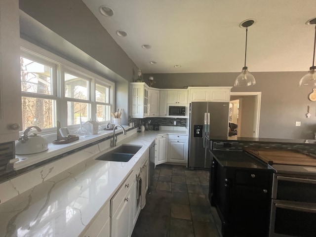 kitchen with white cabinets, sink, pendant lighting, and appliances with stainless steel finishes