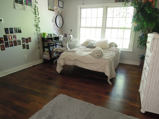 bedroom with dark wood-type flooring