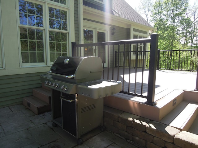 view of patio / terrace featuring a wooden deck and a grill