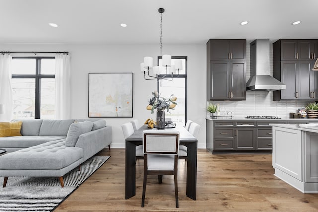 dining space featuring a notable chandelier and light hardwood / wood-style flooring