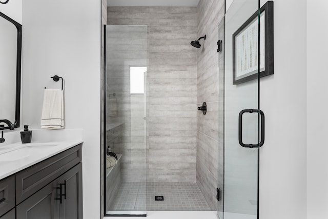 bathroom featuring an enclosed shower and large vanity