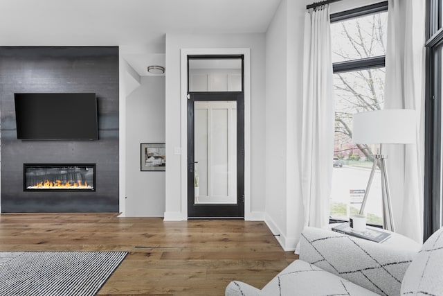 bedroom featuring hardwood / wood-style flooring and a fireplace