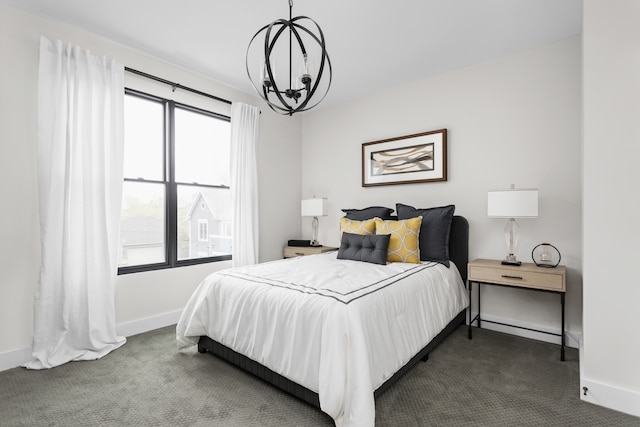 carpeted bedroom featuring an inviting chandelier