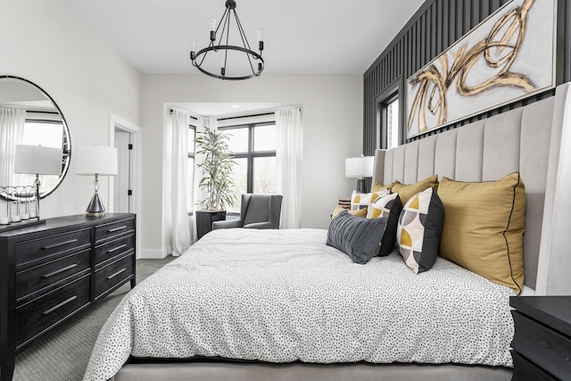 carpeted bedroom with an inviting chandelier