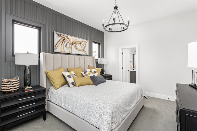 bedroom featuring a notable chandelier, multiple windows, carpet flooring, and ensuite bathroom