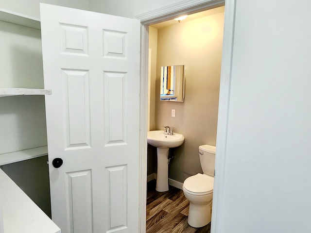 bathroom featuring toilet and hardwood / wood-style floors