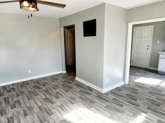 unfurnished room with ceiling fan and wood-type flooring