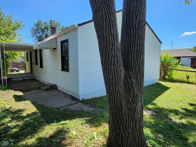 view of side of home with a lawn