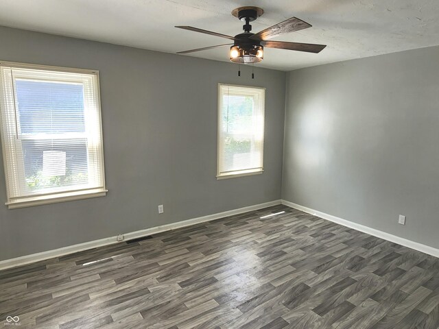 empty room with ceiling fan and hardwood / wood-style floors