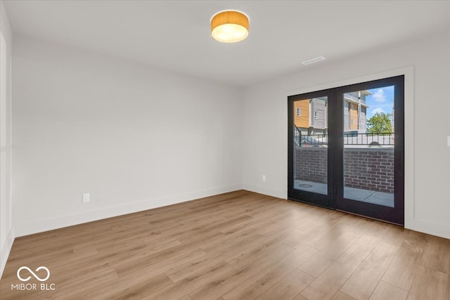 spare room with light hardwood / wood-style flooring