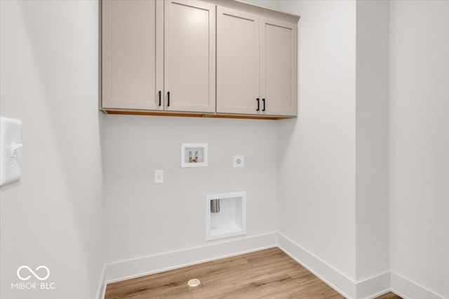 washroom with washer hookup, light hardwood / wood-style flooring, cabinets, and hookup for an electric dryer